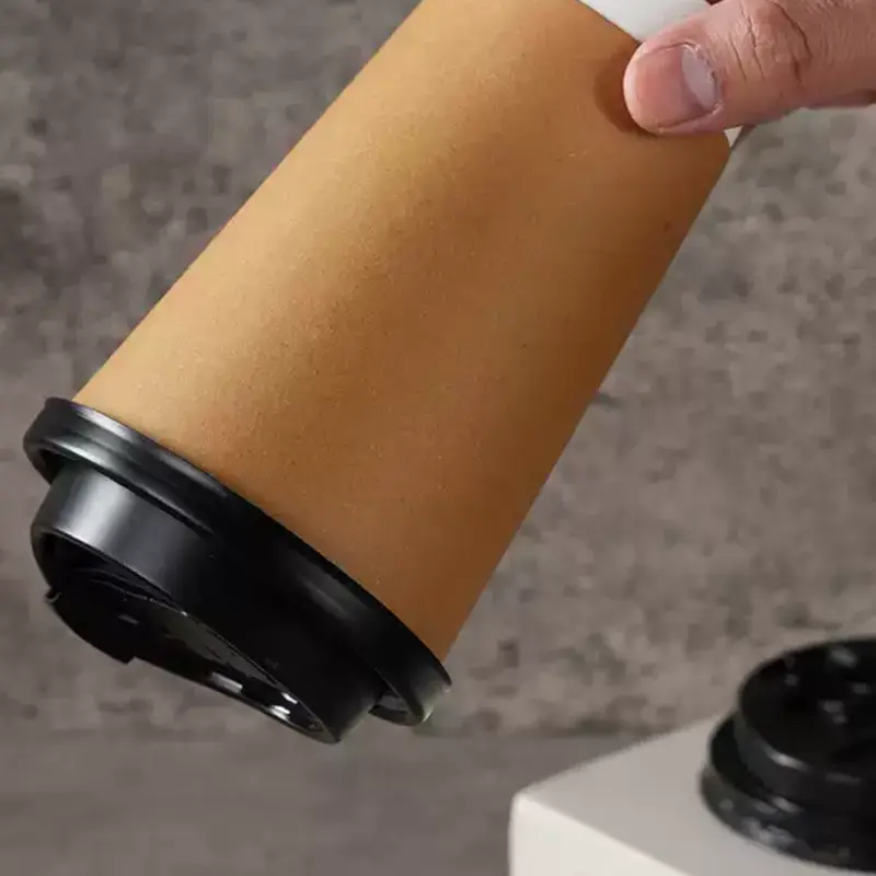 Reference product photograph showing a lid fitted to a double-wall paper cup