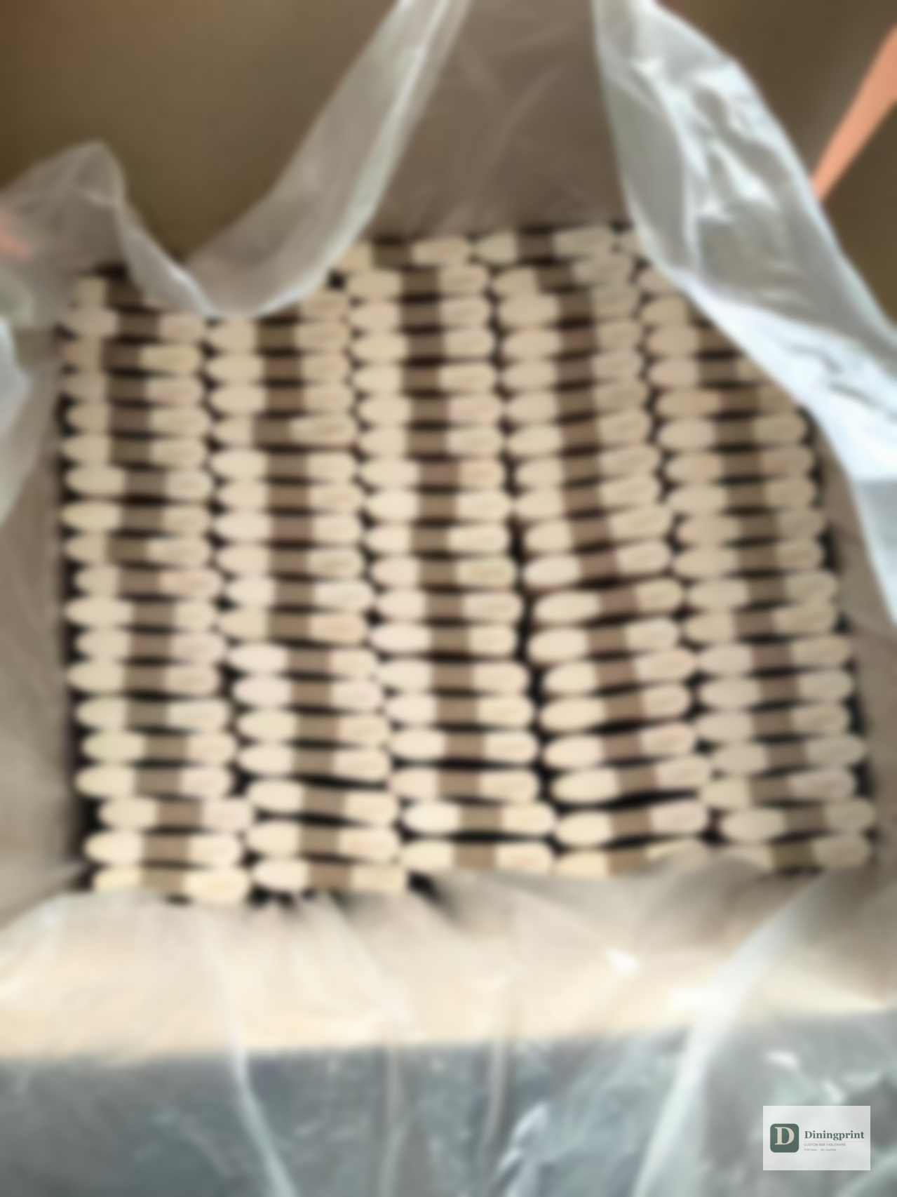 Finished branded disposable sticks packed into a clear bag inside an export carton, viewed from above